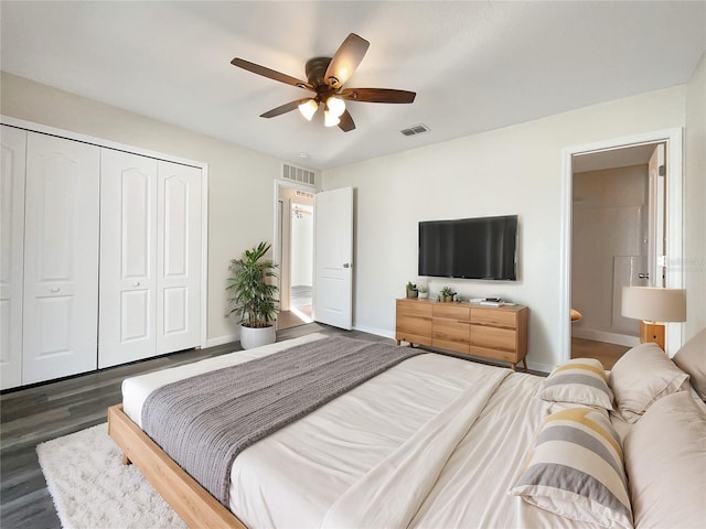 bedroom with a closet, ceiling fan, ensuite bath, and dark hardwood / wood-style flooring