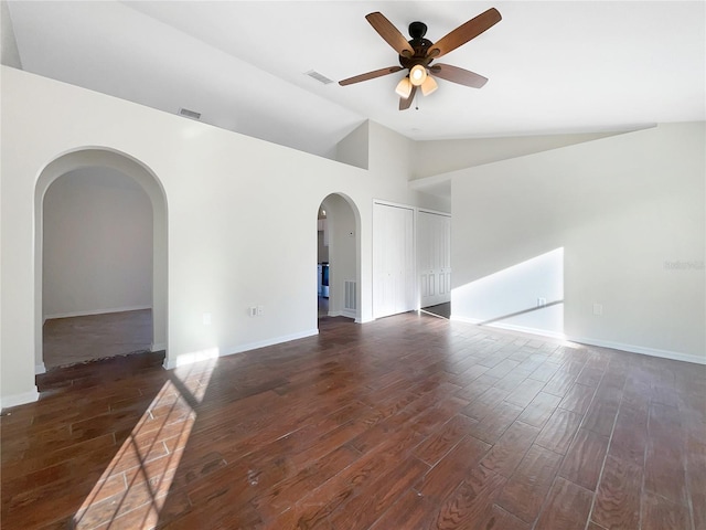 empty room with dark hardwood / wood-style floors, high vaulted ceiling, and ceiling fan