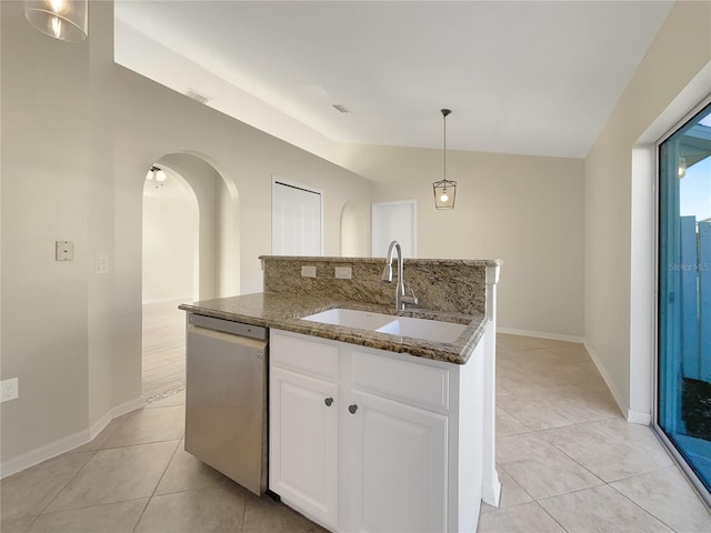 kitchen featuring sink, white cabinetry, lofted ceiling, stainless steel dishwasher, and decorative light fixtures