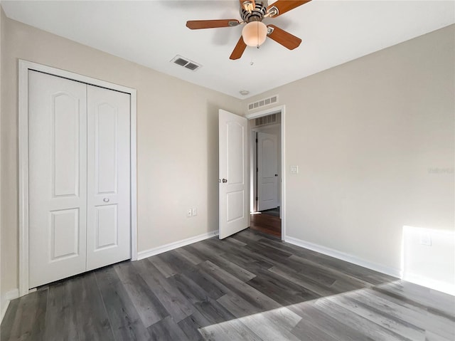 unfurnished bedroom with a closet, ceiling fan, and dark hardwood / wood-style floors