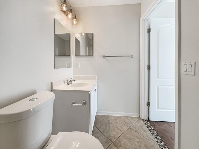 bathroom with vanity, hardwood / wood-style floors, and toilet