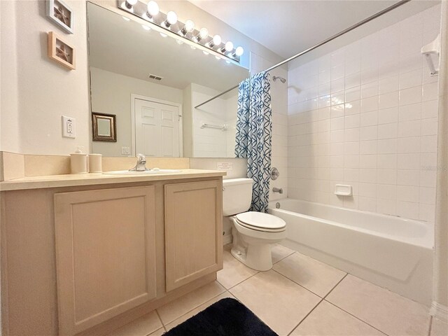 full bathroom featuring tile patterned flooring, shower / tub combo, vanity, and toilet