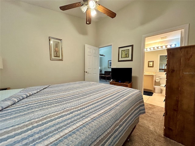 carpeted bedroom featuring ensuite bathroom, ceiling fan, and a high ceiling