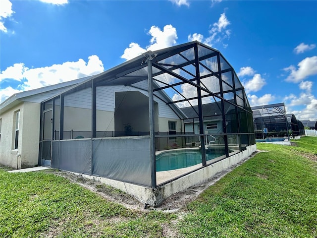 exterior space with a lawn and a lanai