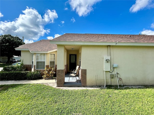 rear view of property featuring a yard