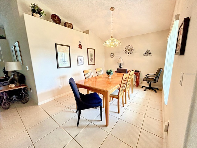 tiled dining area featuring a textured ceiling, vaulted ceiling, and a notable chandelier