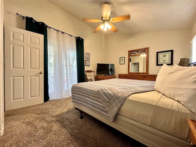 bedroom featuring carpet, ceiling fan, lofted ceiling, and a textured ceiling