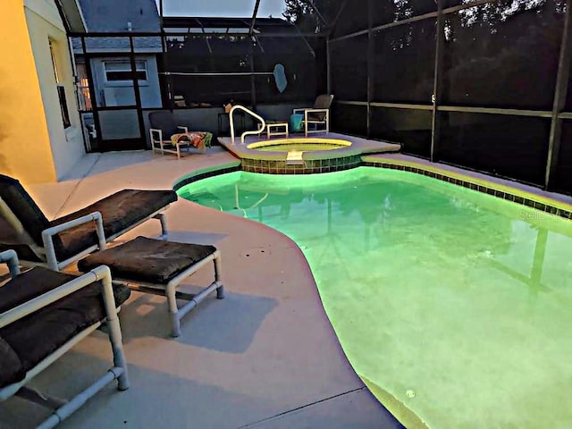 view of swimming pool with an in ground hot tub, a patio, and a lanai