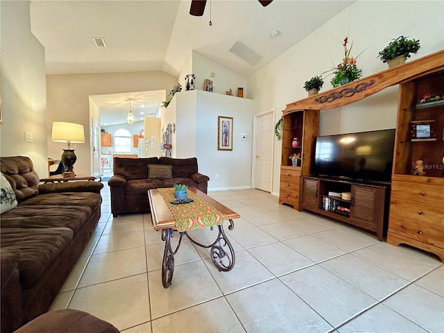 living room featuring ceiling fan, light tile patterned flooring, and lofted ceiling