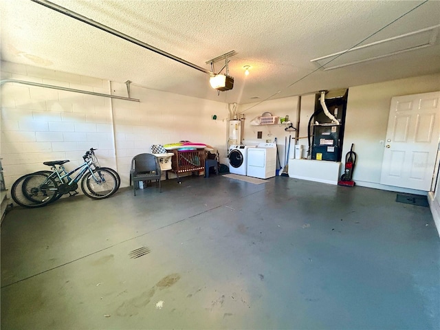 garage with gas water heater, separate washer and dryer, a garage door opener, and heating unit