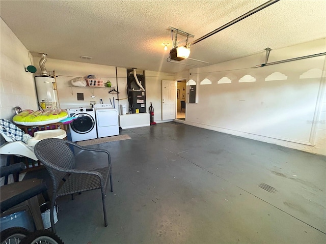 garage featuring heating unit, water heater, independent washer and dryer, electric panel, and a garage door opener