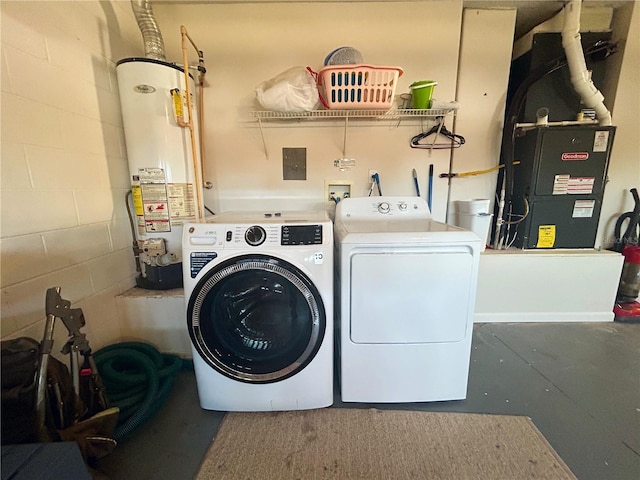 clothes washing area with heating unit, gas water heater, and washing machine and clothes dryer