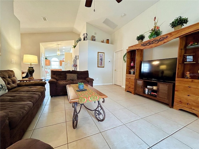 living area featuring light tile patterned floors, ceiling fan, visible vents, and vaulted ceiling