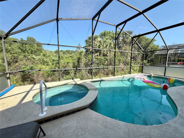 view of swimming pool with a lanai and a pool with connected hot tub