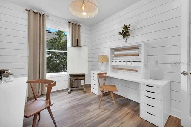 office with dark hardwood / wood-style flooring, wood walls, and a wealth of natural light