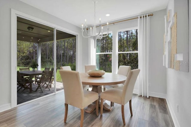 dining room with an inviting chandelier and light hardwood / wood-style flooring