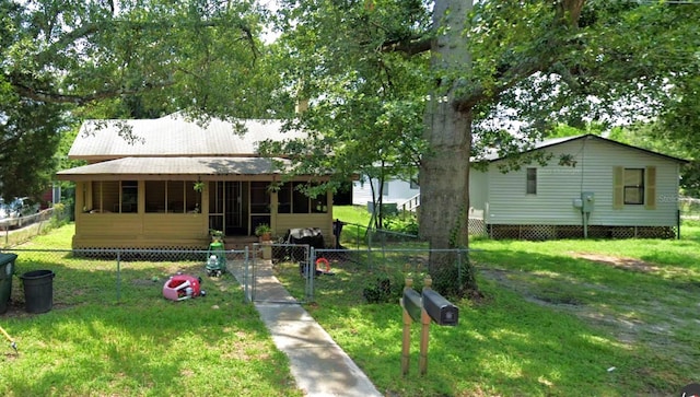 rear view of property featuring a yard