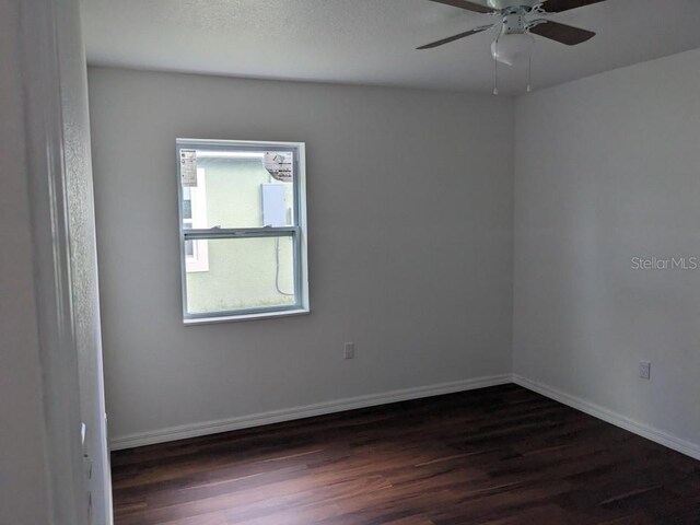 spare room featuring wood-type flooring and ceiling fan