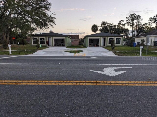 view of front of house with a garage and a yard