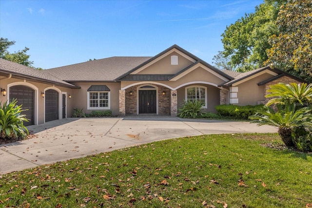 ranch-style home with a garage and a front lawn