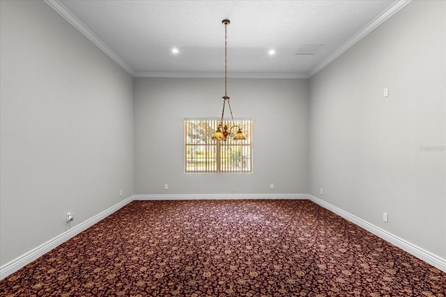 empty room featuring a chandelier, ornamental molding, and carpet