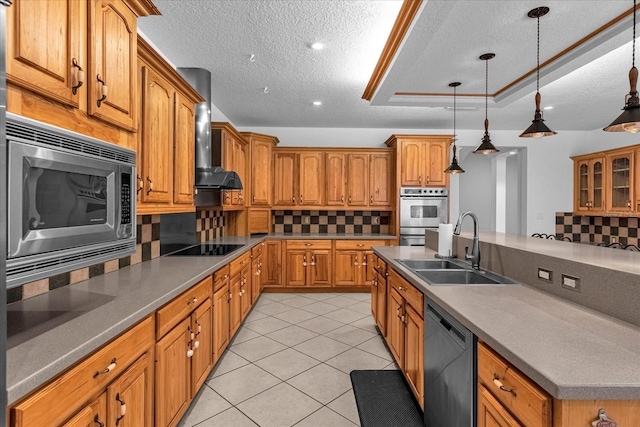 kitchen featuring backsplash, appliances with stainless steel finishes, hanging light fixtures, and sink