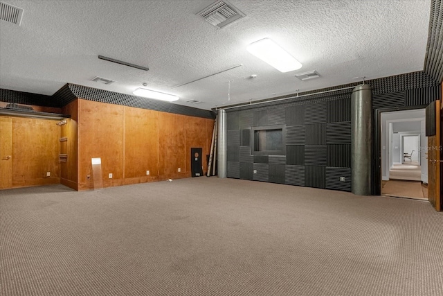 basement featuring carpet and a textured ceiling