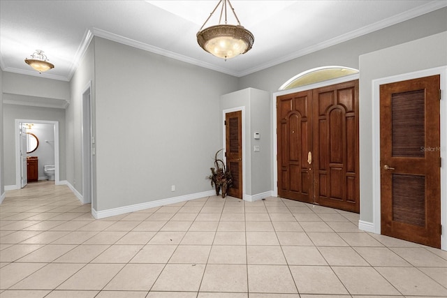 tiled foyer entrance with crown molding