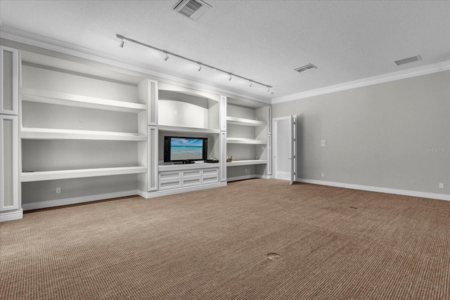 unfurnished living room featuring carpet flooring, rail lighting, built in shelves, and a textured ceiling