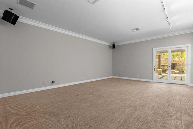 carpeted spare room featuring ornamental molding, track lighting, and a textured ceiling