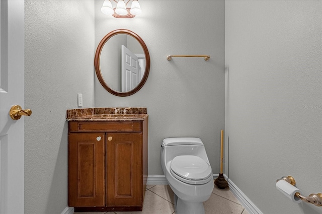 bathroom featuring vanity, toilet, and tile flooring