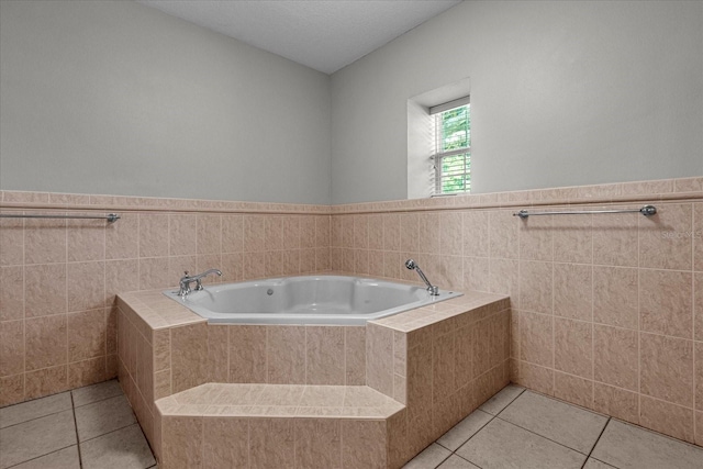 bathroom featuring tile flooring and tiled bath