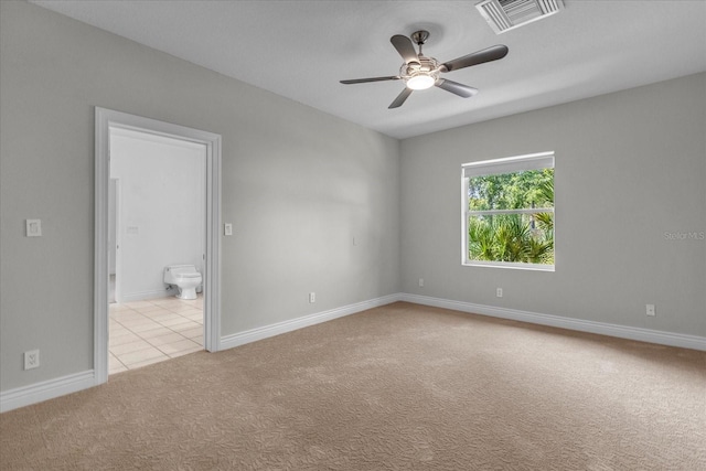 carpeted spare room with ceiling fan