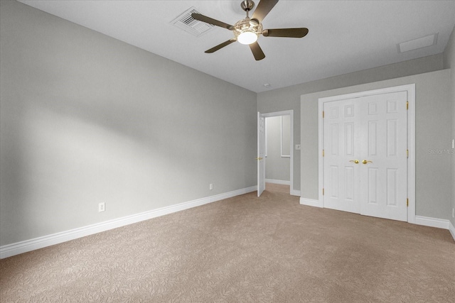 unfurnished bedroom with ceiling fan and carpet