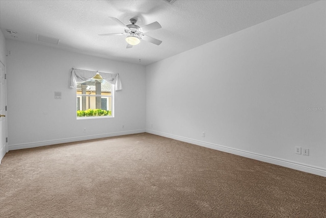 carpeted empty room with ceiling fan and a textured ceiling