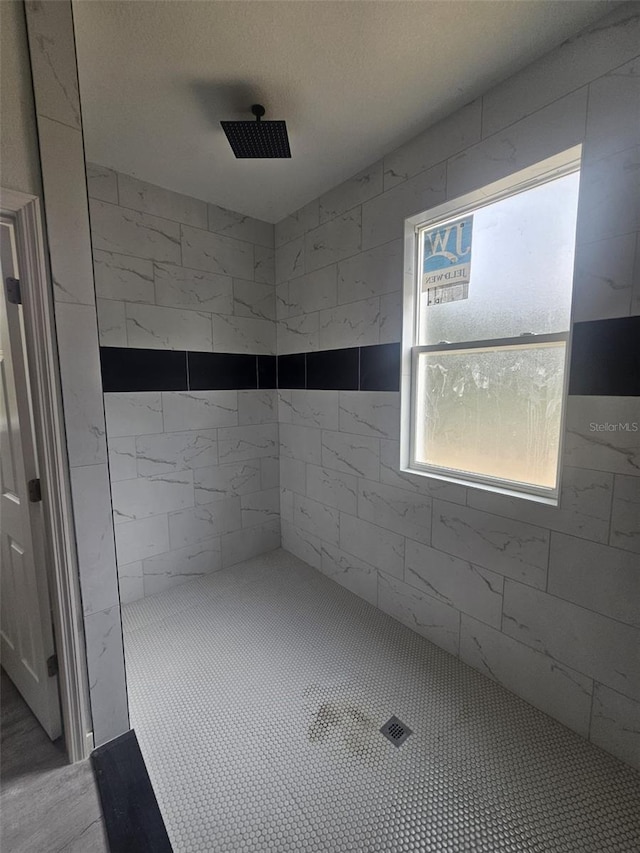 bathroom with a tile shower