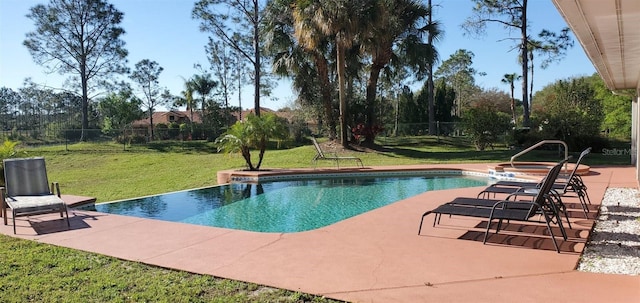 view of swimming pool featuring a patio area and a yard