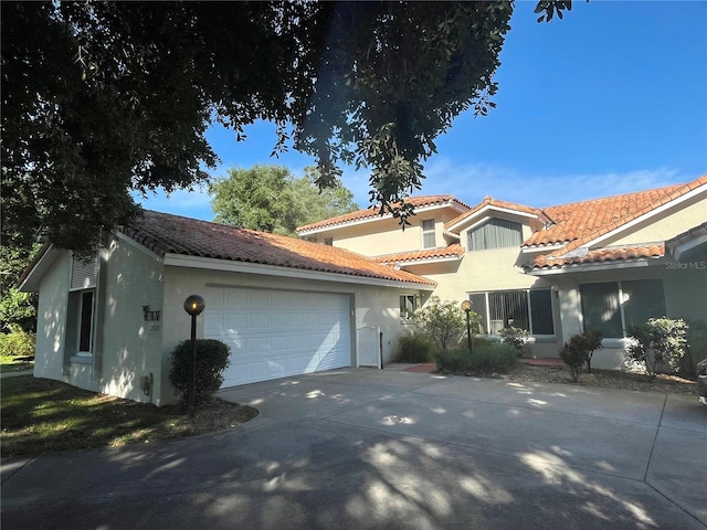 mediterranean / spanish-style home with a garage