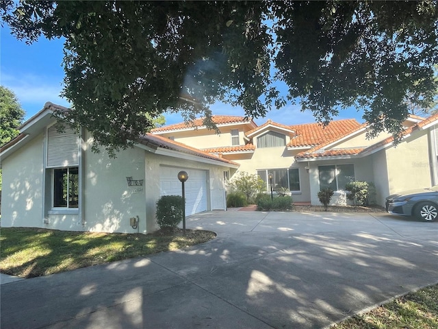 mediterranean / spanish house featuring a garage