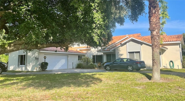 view of front of property with a garage and a front lawn