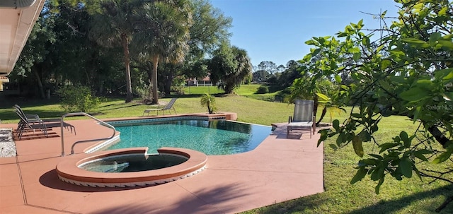 view of pool featuring a patio, a yard, and an in ground hot tub