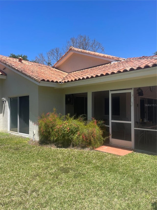 back of property featuring a lawn