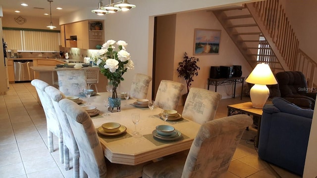 tiled dining room featuring a chandelier