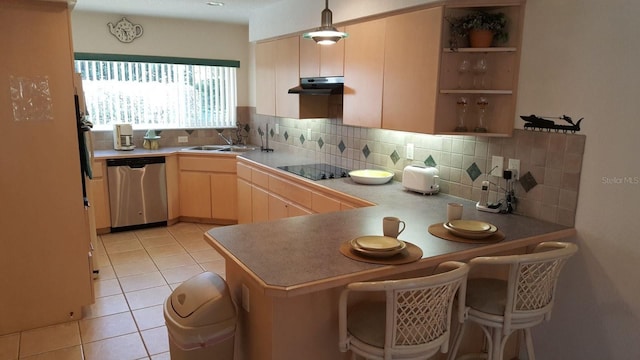 kitchen featuring backsplash, light tile flooring, sink, a breakfast bar, and stainless steel dishwasher