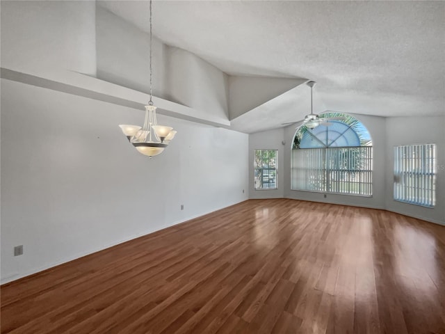 unfurnished room with ceiling fan with notable chandelier, wood-type flooring, high vaulted ceiling, and a textured ceiling