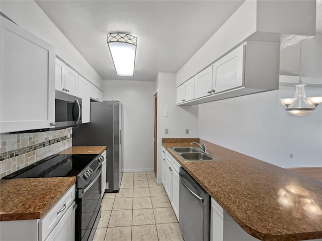 kitchen with pendant lighting, appliances with stainless steel finishes, white cabinets, and sink