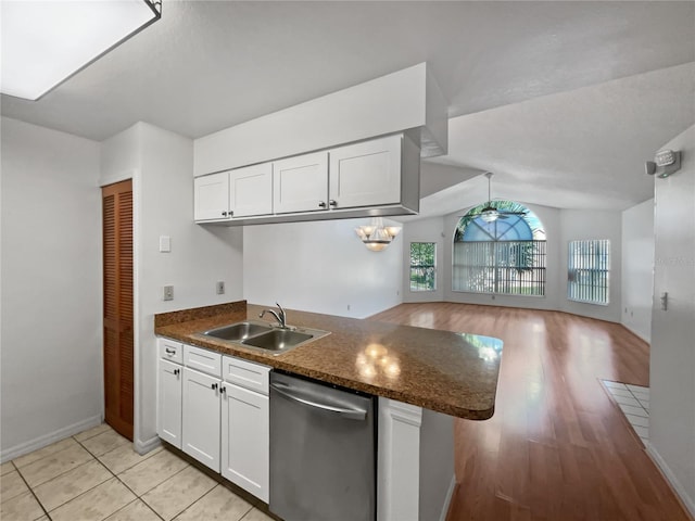 kitchen featuring dark stone counters, white cabinets, sink, light wood-type flooring, and stainless steel dishwasher