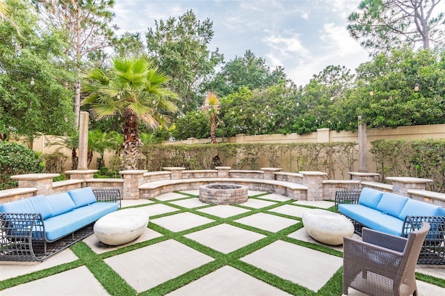 view of patio featuring an outdoor living space with a fire pit