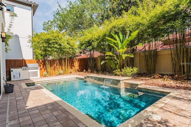 view of pool with a patio, area for grilling, and pool water feature