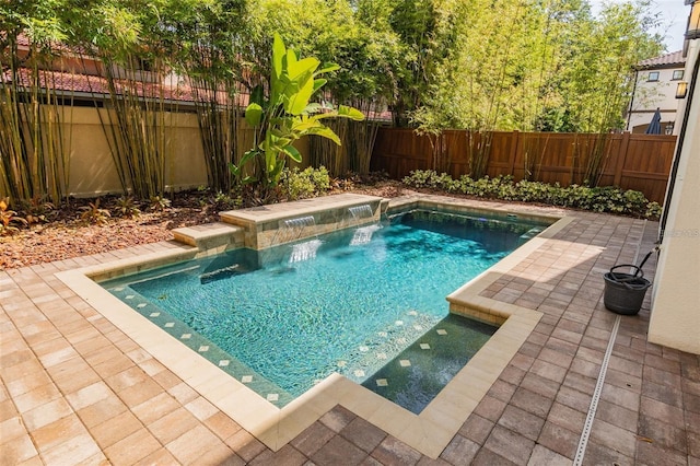 view of swimming pool with a patio and pool water feature